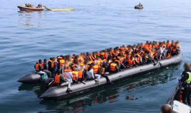 Small boat on the water containing people in life jackets
